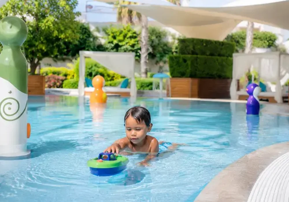 Kids' splash pad and water slide at the Al Ghadeer pool deck