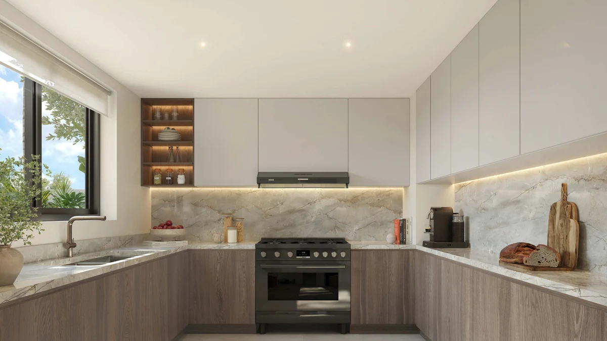 Wide view of an Al Ghadeer Gardens kitchen, dark palette