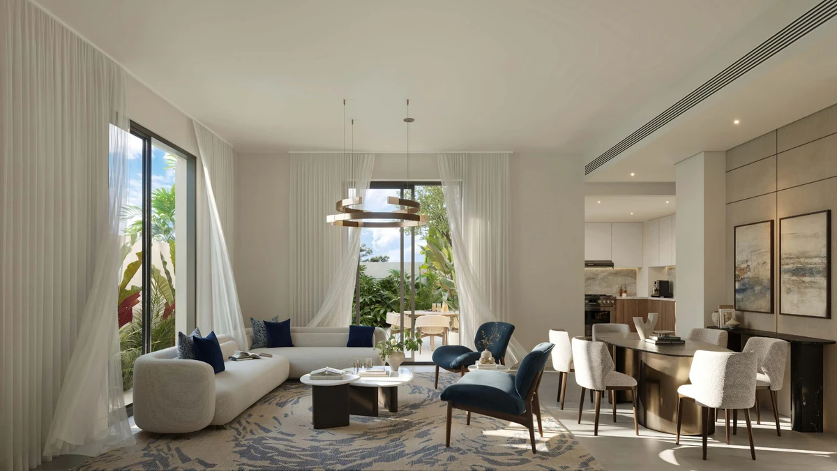 Wide view of an Al Ghadeer Gardens living room, dark palette