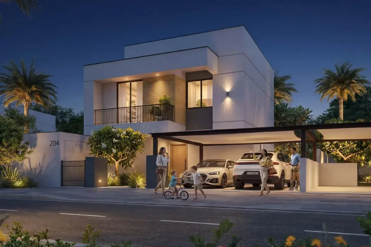 Al Ghadeer 4-bedroom villa at night with glowing windows and driveway